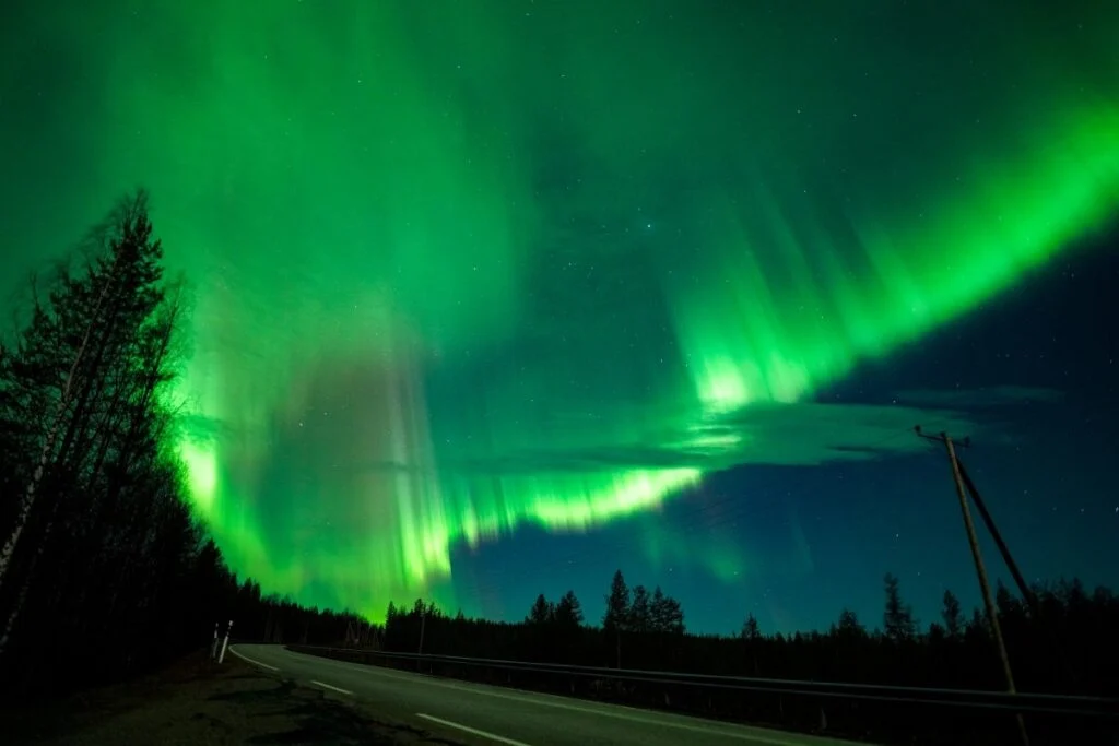 Northern Lights over a roadside clearing near Rovaniemi, Finnish Lapland