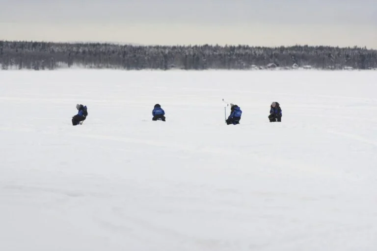 Ice fishing on a frozen lake near Rovaniemi