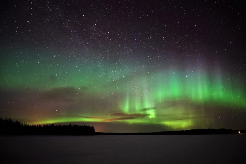 March aurora over the Taiga forest near Rovaniemi