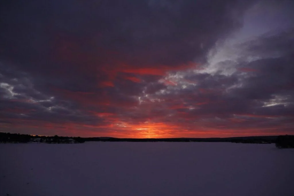 Winter sunrise over snow-covered Rovaniemi with low Arctic light, Finnish Lapland