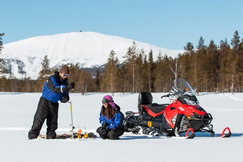 Snowmobile safari with ice fishing and outdoor lunch in Levi